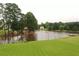 Scenic lake view with an American flag on the shoreline and lush greenery surrounding the tranquil water at 794 Rutland Ct, Lithonia, GA 30058
