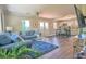 Cozy living room with hardwood floors, blue sofa, and view into the kitchen and dining area at 794 Rutland Ct, Lithonia, GA 30058