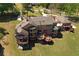 Aerial view of the home with multiple decks and a large manicured lawn on a sunny day at 794 Rutland Ct, Lithonia, GA 30058