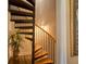 Unique spiral staircase with wooden steps and black metal railing at 794 Rutland Ct, Lithonia, GA 30058