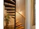 Unique spiral staircase with wooden steps and iron railings, complemented by a plant for a touch of nature indoors at 794 Rutland Ct, Lithonia, GA 30058