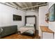 Murphy bed pulled down in a spare bedroom with hardwood floors and shelving at 805 Peachtree Ne St # 411, Atlanta, GA 30308