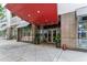 Inviting building entrance with a red awning, clean sidewalk, and storefront windows on a well-maintained city street at 805 Peachtree Ne St # 411, Atlanta, GA 30308