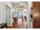 Hallway leading to an open living space with exposed piping and hardwood floors at 805 Peachtree Ne St # 411, Atlanta, GA 30308