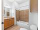 Cozy bathroom featuring wood cabinets, bathtub with tile, and neutral walls at 825 Highland Lane Northeast Ne # 1313, Atlanta, GA 30306