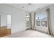 This bedroom has a balcony access, a window, neutral walls, and carpet at 825 Highland Lane Northeast Ne # 1313, Atlanta, GA 30306