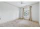 This bedroom features a large window, neutral walls, carpet, and base trim at 825 Highland Lane Northeast Ne # 1313, Atlanta, GA 30306