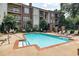 Outdoor pool area has comfortable lounge chairs with nearby patio tables for relaxing at 825 Highland Lane Northeast Ne # 1313, Atlanta, GA 30306