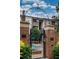 An outdoor pool area with wrought iron gate, brick facade, and manicured landscaping at 825 Highland Lane Northeast Ne # 1313, Atlanta, GA 30306