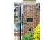 Elegant brick entrance sign for The Carlton, established in 2003, with manicured greenery and a glimpse of the community pool at 825 Highland Lane Northeast Ne # 1313, Atlanta, GA 30306