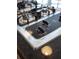 Close-up of a gas cooktop surface with stainless steel burners and black knobs at 825 Highland Lane Northeast Ne # 1313, Atlanta, GA 30306