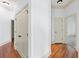Hallway with hardwood floors, white trim, doors and neutral paint at 825 Highland Lane Northeast Ne # 1313, Atlanta, GA 30306