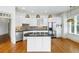 Spacious kitchen with white cabinets, an island cooktop, and pendant lighting fixtures at 825 Highland Lane Northeast Ne # 1313, Atlanta, GA 30306