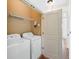 Well-lit laundry room with a washer and dryer, wire shelving, and beige walls at 825 Highland Lane Northeast Ne # 1313, Atlanta, GA 30306