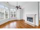 Cozy living room with hardwood floors, fireplace, and a bank of windows with shade blinds at 825 Highland Lane Northeast Ne # 1313, Atlanta, GA 30306