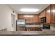 This modern kitchen features stainless steel appliances, tile backsplash, and warm wood cabinetry at 3650 Ashford Dunwoody Ne Rd # 514, Atlanta, GA 30319