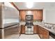 Well-equipped kitchen with stainless steel appliances and warm-toned cabinets offers functionality at 3650 Ashford Dunwoody Ne Rd # 514, Atlanta, GA 30319