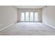 Bright living room with neutral walls, plush carpet, and a large glass door leading to a balcony at 3650 Ashford Dunwoody Ne Rd # 514, Atlanta, GA 30319