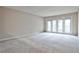 Spacious living room with neutral walls and carpet, illuminated by natural light from a glass door at 3650 Ashford Dunwoody Ne Rd # 514, Atlanta, GA 30319