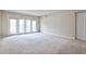 Inviting living room features neutral walls, plush carpet, and a balcony door for natural light at 3650 Ashford Dunwoody Ne Rd # 514, Atlanta, GA 30319
