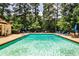 Inviting community pool with lounge chairs surrounded by lush greenery on a sunny day at 3650 Ashford Dunwoody Ne Rd # 514, Atlanta, GA 30319