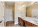 Bathroom featuring double sinks with granite counters, vanity and enclosed shower at 5060 Windcrest Lane, Alpharetta, GA 30022