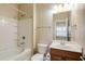 Bathroom with a tub and shower combination, wood vanity, large mirror, and neutral walls at 5060 Windcrest Lane, Alpharetta, GA 30022