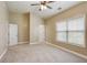 An ample bedroom with plush carpet, neutral walls, large windows and two entry doors at 5060 Windcrest Lane, Alpharetta, GA 30022