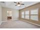 Spacious bedroom with neutral walls, a trey ceiling with fan, and lots of natural light from three windows at 5060 Windcrest Lane, Alpharetta, GA 30022