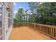 Wood deck with room for outdoor seating overlooking lush scenery at 5060 Windcrest Lane, Alpharetta, GA 30022