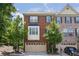 Charming brick townhome featuring a two-car garage and inviting curb appeal at 5060 Windcrest Lane, Alpharetta, GA 30022