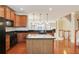 Spacious kitchen with wooden cabinets, a kitchen island, and hardwood floors at 5060 Windcrest Lane, Alpharetta, GA 30022