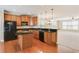 Modern kitchen with granite countertops, stainless appliances, and hardwood floors at 5060 Windcrest Lane, Alpharetta, GA 30022