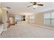 Open-concept living space with connecting kitchen, plush carpets and natural light at 5060 Windcrest Lane, Alpharetta, GA 30022