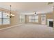 Spacious living room with plush carpet, fireplace and large windows with natural light at 5060 Windcrest Lane, Alpharetta, GA 30022