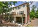 Exterior rear view of a multi-story home with wooden decks and a brick foundation at 5060 Windcrest Lane, Alpharetta, GA 30022