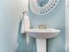 Pedestal sink with brushed nickel faucet, bright and clean bathroom at 6940 Roswell Road Rd # 16B, Atlanta, GA 30328