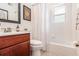 Bathroom features a single sink vanity, framed mirror, and shower-tub combo with stylish curtain at 6940 Roswell Road Rd # 16B, Atlanta, GA 30328