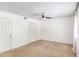 This bedroom features neutral carpet, a ceiling fan, and a double-door closet for ample storage at 6940 Roswell Road Rd # 16B, Atlanta, GA 30328