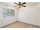 Bright bedroom with a ceiling fan, neutral carpet, and a large window offering natural light at 6940 Roswell Road Rd # 16B, Atlanta, GA 30328