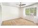 Bright bedroom with a ceiling fan and large window with white curtains, filling the room with natural light at 6940 Roswell Road Rd # 16B, Atlanta, GA 30328
