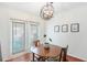 Cozy dining area featuring a modern light fixture and a view to the back patio at 6940 Roswell Road Rd # 16B, Atlanta, GA 30328