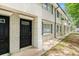 Well-maintained exterior shows a brick and siding condo unit with black door, adding curb appeal to the property at 6940 Roswell Road Rd # 16B, Atlanta, GA 30328