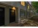 Front door of a multi-Gathering property featuring a dark door, exterior lighting, and brick and vinyl siding at 6940 Roswell Road Rd # 16B, Atlanta, GA 30328