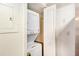 Stacked white washer and dryer units inside a laundry closet with bi-fold doors at 6940 Roswell Road Rd # 16B, Atlanta, GA 30328