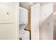 A stacked washer and dryer nestled in a small utility closet at 6940 Roswell Road Rd # 16B, Atlanta, GA 30328
