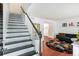 Bright living room boasts a striking staircase, hardwood floors, and stylish decor, offering a comfortable living space at 6940 Roswell Road Rd # 16B, Atlanta, GA 30328