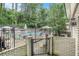 Gated pool area, with lounge chairs and trees for shade in a community setting at 6940 Roswell Road Rd # 16B, Atlanta, GA 30328