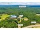 Expansive aerial shot showcasing the home's private setting, surrounded by lush trees and a long driveway at 705 S Bethany Rd, Mcdonough, GA 30252