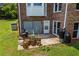 Backyard with grilling area, storage area, garage door, and lush green lawn at 705 S Bethany Rd, Mcdonough, GA 30252